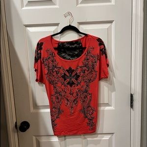 Great shirt. Orange/black with nice designs. Black back is sheer